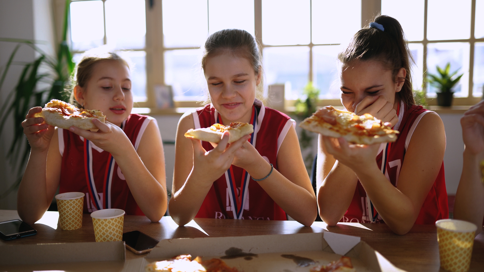 Team mates enjoying a pizza together