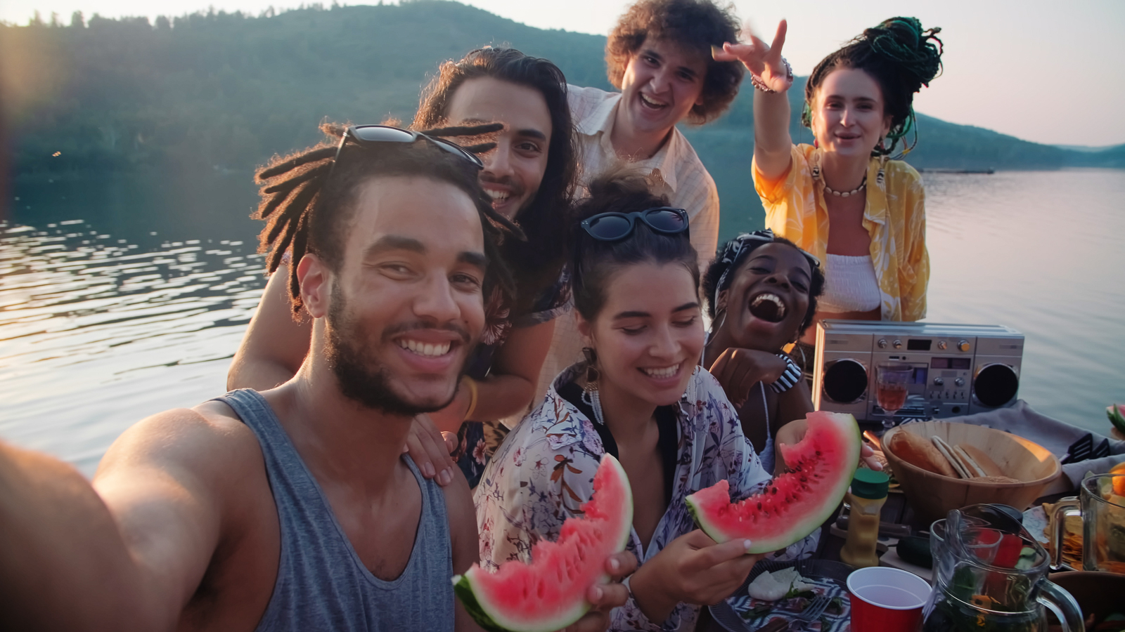 Friends taking a selfie with their fresh watermelon pieces